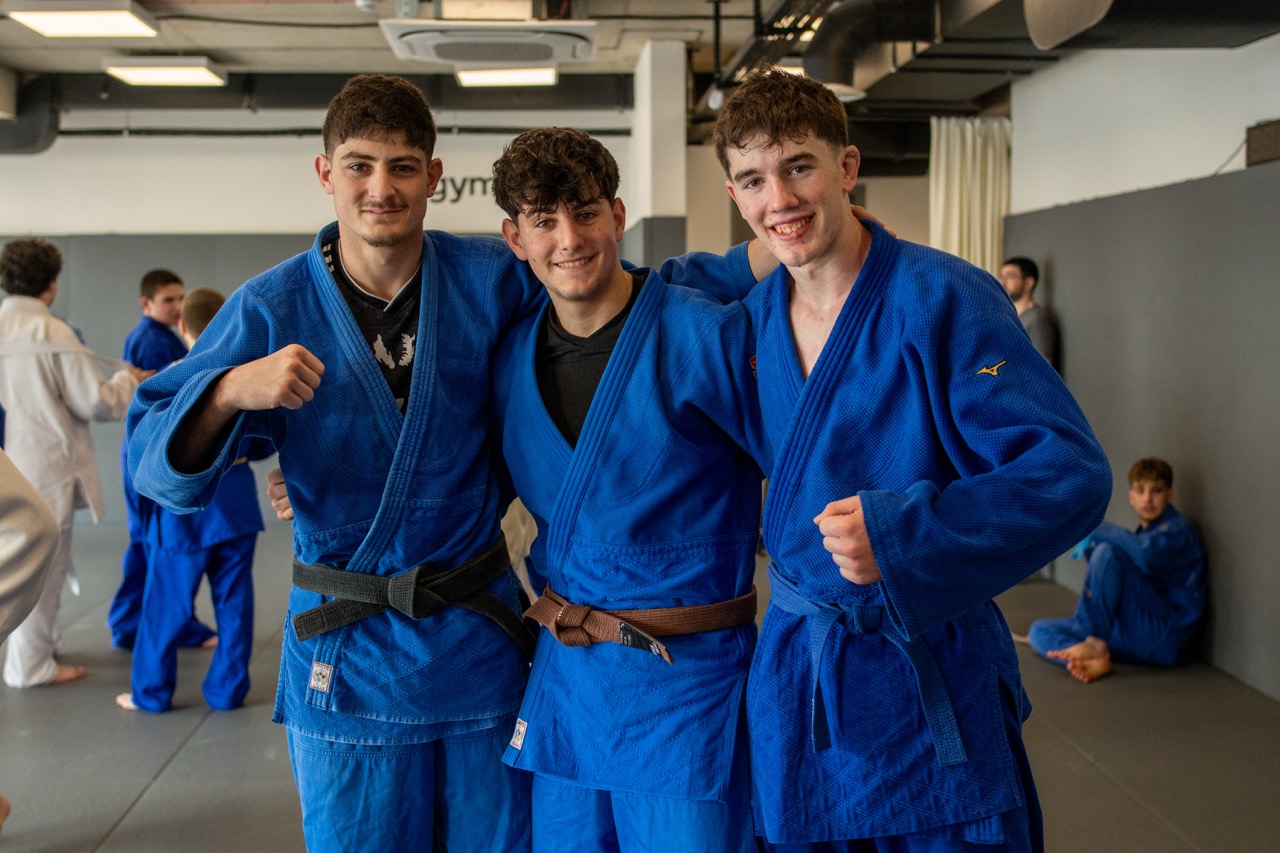 Judoka lining up on the mat during an international judo camp session in Tbilisi
