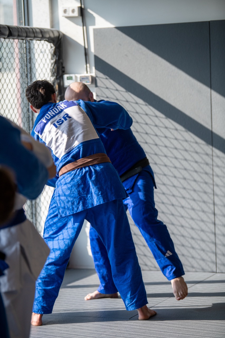 International judo group gathered on the mat during a Tbilisi camp